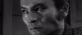 Movie still from “Harakiri” (1962), directed by Masaki Kobayashi – A man's face in black - and - white; Close Up shot, Low angle