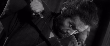 Movie still from “Harakiri” (1962), directed by Masaki Kobayashi – Black and white photograph of a man holding a sword; Close Up shot, Low angle