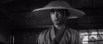 Movie still from “Harakiri” (1962), directed by Masaki Kobayashi – A man wearing a straw hat and a robe; Close Up shot, Low angle