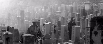 Movie still from “Harakiri” (1962), directed by Masaki Kobayashi – Two men standing next to each other in front of a cemetery; Wide shot, High angle