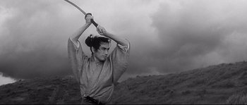 Movie still from “Harakiri” (1962), directed by Masaki Kobayashi – A man holding a sword in his hands; Medium shot, Low angle
