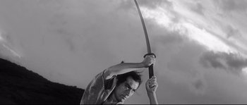 Movie still from “Harakiri” (1962), directed by Masaki Kobayashi – A man is holding a sword in the air; Medium shot, Low angle