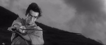 Movie still from “Harakiri” (1962), directed by Masaki Kobayashi – A black - and - white photo of a man in a scarf; Close Up shot, Low angle