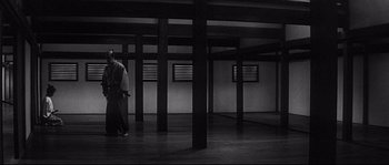 Movie still from “Harakiri” (1962), directed by Masaki Kobayashi – Two people are walking in a room with pillars; Extreme Wide shot, Low angle