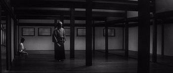 Movie still from “Harakiri” (1962), directed by Masaki Kobayashi – A man in a kimono stands in an empty room; Wide shot, Low angle