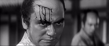 Movie still from “Harakiri” (1962), directed by Masaki Kobayashi – A black and white photo of a man with a face covered in blood; Close Up shot, Low angle