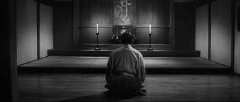 Movie still from “Harakiri” (1962), directed by Masaki Kobayashi – A man kneeling down in front of a cross in a church; Wide shot, Low angle