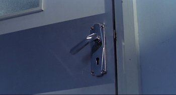 Movie still from “Hard Boiled” (1992), directed by John Woo – A door handle with a keyhole; Extreme Close Up shot, High angle