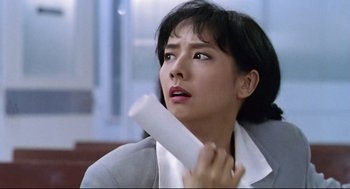 Movie still from “Hard Boiled” (1992), directed by John Woo – A woman holding onto a piece of toilet paper; Close Up shot, Low angle