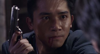 Movie still from “Hard Boiled” (1992), directed by John Woo – A person with blood on his face; Close Up shot, High angle