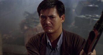 Movie still from “Hard Boiled” (1992), directed by John Woo – A person wearing a brown jacket; Close Up shot, Low angle
