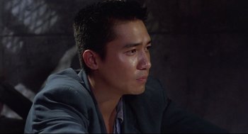 Movie still from “Hard Boiled” (1992), directed by John Woo – A person wearing a jacket; Close Up shot, Low angle