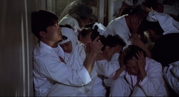 Movie still from “Hard Boiled” (1992), directed by John Woo – A group of young people in white robes gathered together; Medium shot, High angle