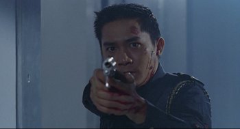 Movie still from “Hard Boiled” (1992), directed by John Woo – A man with blood on his face holding a gun; Close Up shot, Low angle