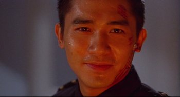 Movie still from “Hard Boiled” (1992), directed by John Woo – A person with blood on his face; Close Up shot, Low angle