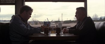 Movie still from “Hard Eight” (1996), directed by Paul Thomas Anderson – Two people sitting at a table with a drink; Medium shot, Low angle
