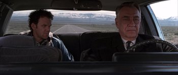Movie still from “Hard Eight” (1996), directed by Paul Thomas Anderson – A man and a woman sitting in the back seat of a car; Medium shot, Low angle