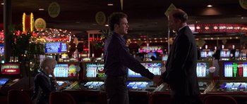 Movie still from “Hard Eight” (1996), directed by Paul Thomas Anderson – Two men shaking hands in a casino room; Medium shot, Low angle