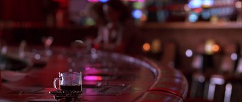 Movie still from “Hard Eight” (1996), directed by Paul Thomas Anderson – A glass of alcohol on a bar in a night club; Extreme Close Up shot, Over the shoulder angle