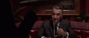 Movie still from “Hard Eight” (1996), directed by Paul Thomas Anderson – An older man in a suit and tie sitting at a table; Close Up shot, Over the shoulder angle