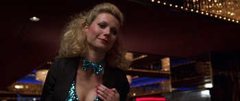 Movie still from “Hard Eight” (1996), directed by Paul Thomas Anderson – A woman in a black jacket and a blue bow tie; Close Up shot, Low angle