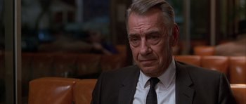 Movie still from “Hard Eight” (1996), directed by Paul Thomas Anderson – An older man wearing a suit and tie; Close Up shot, Over the shoulder angle