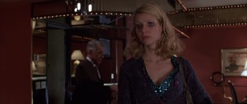 Movie still from “Hard Eight” (1996), directed by Paul Thomas Anderson – A woman in a dress standing in front of a man in a suit; Medium shot, Over the shoulder angle
