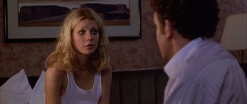 Movie still from “Hard Eight” (1996), directed by Paul Thomas Anderson – A young woman looking at a young man in front of a mirror; Close Up shot, Over the shoulder angle