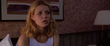 Movie still from “Hard Eight” (1996), directed by Paul Thomas Anderson – A young woman sitting in front of a wall looking sad; Close Up shot, Low angle