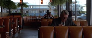 Movie still from “Hard Eight” (1996), directed by Paul Thomas Anderson – A man sitting at a table in a restaurant; Medium shot, Over the shoulder angle