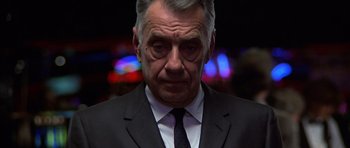 Movie still from “Hard Eight” (1996), directed by Paul Thomas Anderson – An older man wearing a suit and tie; Close Up shot, Low angle