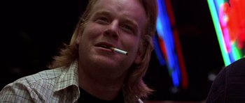 Movie still from “Hard Eight” (1996), directed by Paul Thomas Anderson – A person smoking a cigarette; Close Up shot, Low angle