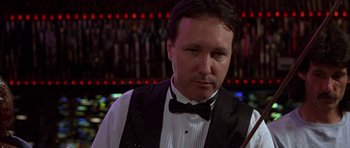 Movie still from “Hard Eight” (1996), directed by Paul Thomas Anderson – A man wearing a tuxedo and a bow tie in front of a bar; Close Up shot, Low angle