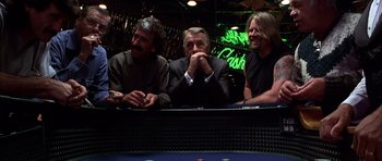 Movie still from “Hard Eight” (1996), directed by Paul Thomas Anderson – A group of men sitting at a table in front of cards; Medium shot, Over the shoulder angle