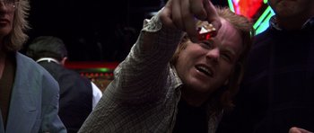Movie still from “Hard Eight” (1996), directed by Paul Thomas Anderson – A man holding a cell phone up to his face; Close Up shot, Over the shoulder angle