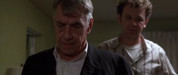 Movie still from “Hard Eight” (1996), directed by Paul Thomas Anderson – An older man wearing a suit and a tie; Close Up shot, Low angle