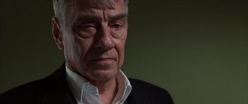 Movie still from “Hard Eight” (1996), directed by Paul Thomas Anderson – An older man wearing a white shirt and a black jacket; Close Up shot, Over the shoulder angle