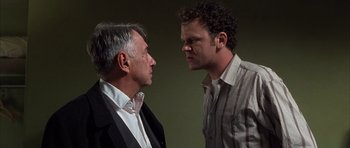 Movie still from “Hard Eight” (1996), directed by Paul Thomas Anderson – A man and a man standing next to each other; Close Up shot, Over the shoulder angle