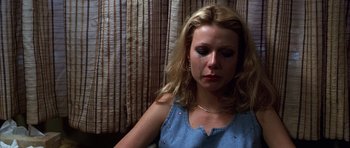 Movie still from “Hard Eight” (1996), directed by Paul Thomas Anderson – A woman sitting in front of a wall with tears coming from her eyes; Close Up shot, High angle