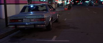 Movie still from “Hard Eight” (1996), directed by Paul Thomas Anderson – A car is driving down the street at night; Wide shot, Low angle