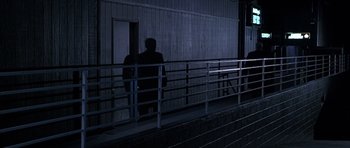 Movie still from “Hard Eight” (1996), directed by Paul Thomas Anderson – A man standing on the steps of a building at night; Extreme Wide shot, High angle