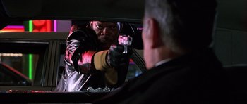 Movie still from “Hard Eight” (1996), directed by Paul Thomas Anderson – A man in a leather jacket is holding a gun; Close Up shot, Over the shoulder angle