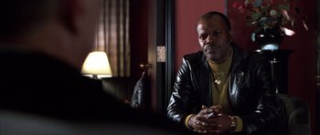 Movie still from “Hard Eight” (1996), directed by Paul Thomas Anderson – A man in a leather jacket sitting in front of a lamp; Close Up shot, Over the shoulder angle