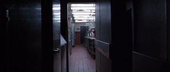 Movie still from “Hard Eight” (1996), directed by Paul Thomas Anderson – A kitchen with a lot of cabinets in it; Wide shot, High angle