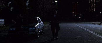 Movie still from “Hard Eight” (1996), directed by Paul Thomas Anderson – A man standing next to a car in the dark at night; Wide shot, Low angle