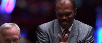 Movie still from “Hard Eight” (1996), directed by Paul Thomas Anderson – A person wearing a suit and tie; Close Up shot, Low angle