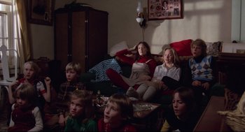 Movie still from “Hardcore” (1979), directed by Paul Schrader – A group of people sitting in a living room watching tv; Wide shot, High angle