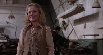 Movie still from “Hardcore” (1979), directed by Paul Schrader – A woman standing in front of a man in a room; Medium shot, Low angle