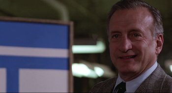 Movie still from “Hardcore” (1979), directed by Paul Schrader – A person wearing a suit and tie; Close Up shot, Low angle