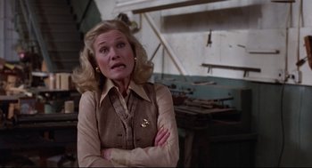 Movie still from “Hardcore” (1979), directed by Paul Schrader – An older woman with blonde hair wearing a brown jacket; Medium shot, Low angle